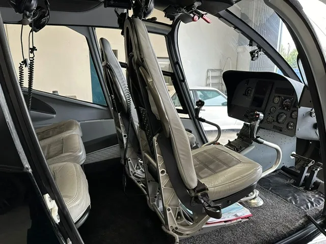 Interior view of the helicopter cabin with gray seats.