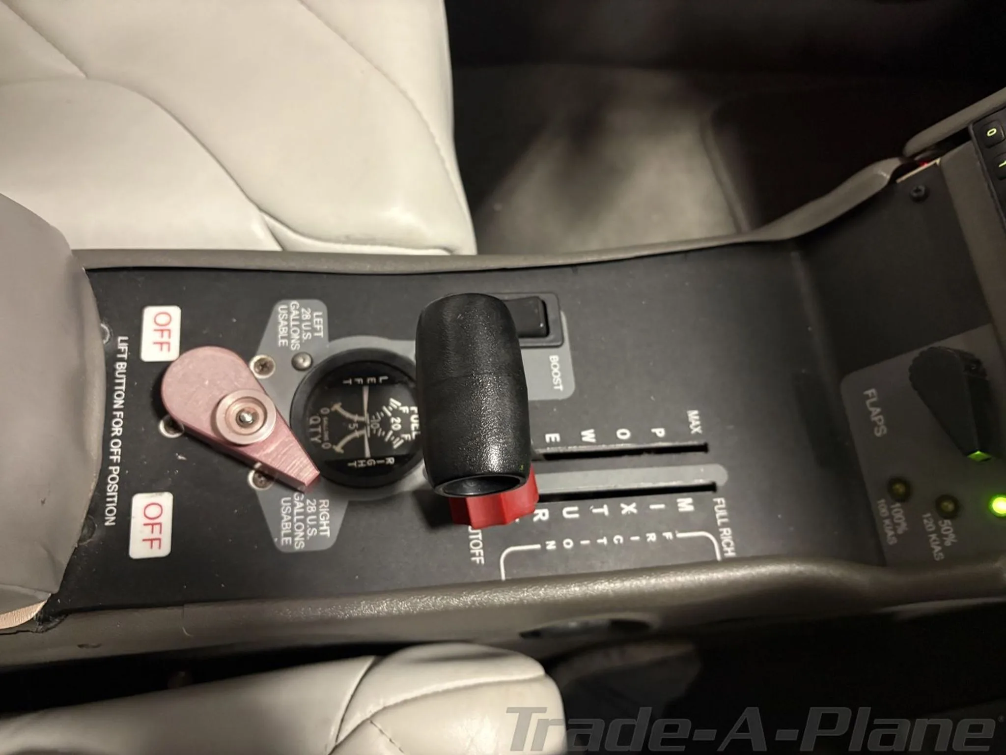 A close-up view of the center console in a Cirrus SR20 cockpit, showing the throttle, mixture, and flap controls.