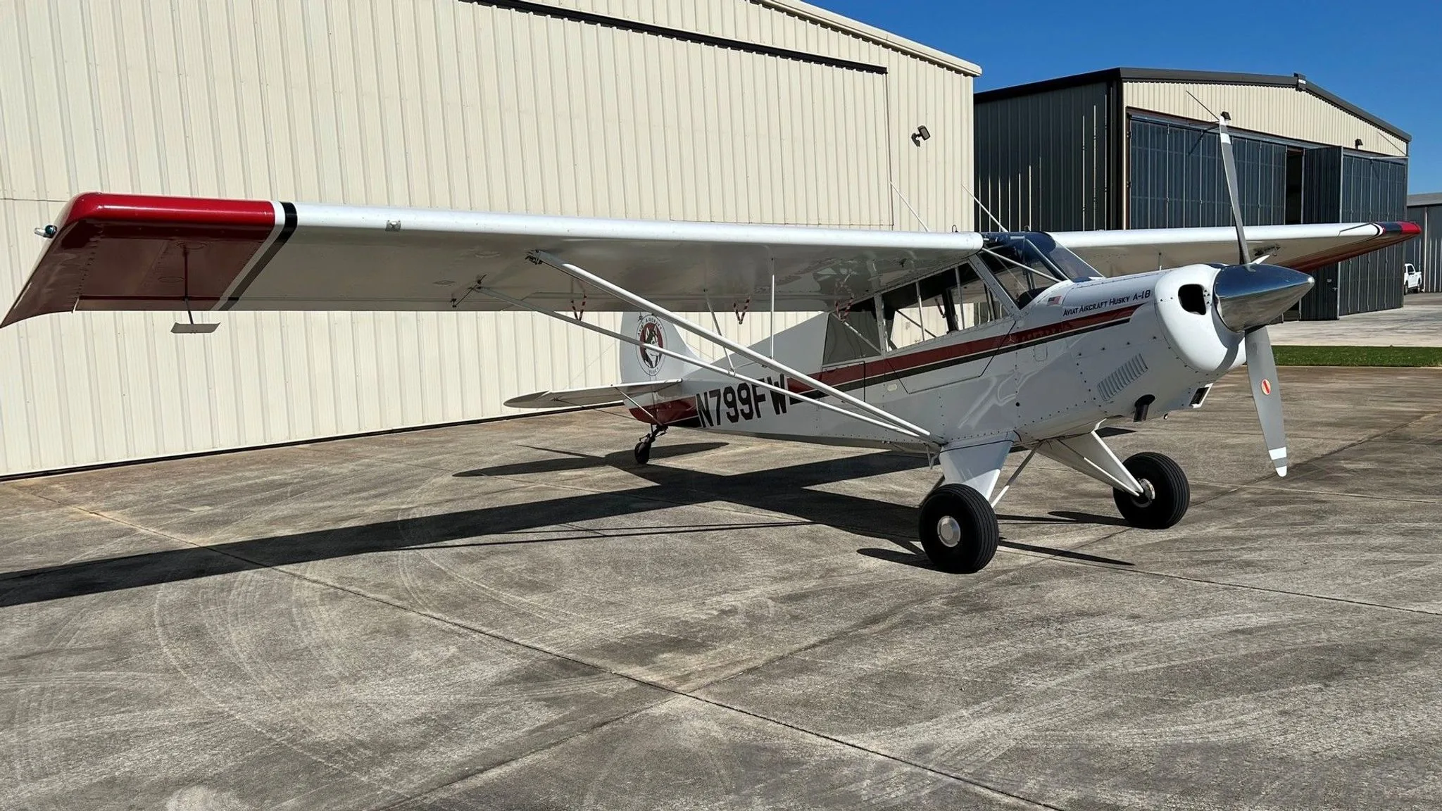 Another angle of the 1999 Aviat Husky A-1B parked at an airport.