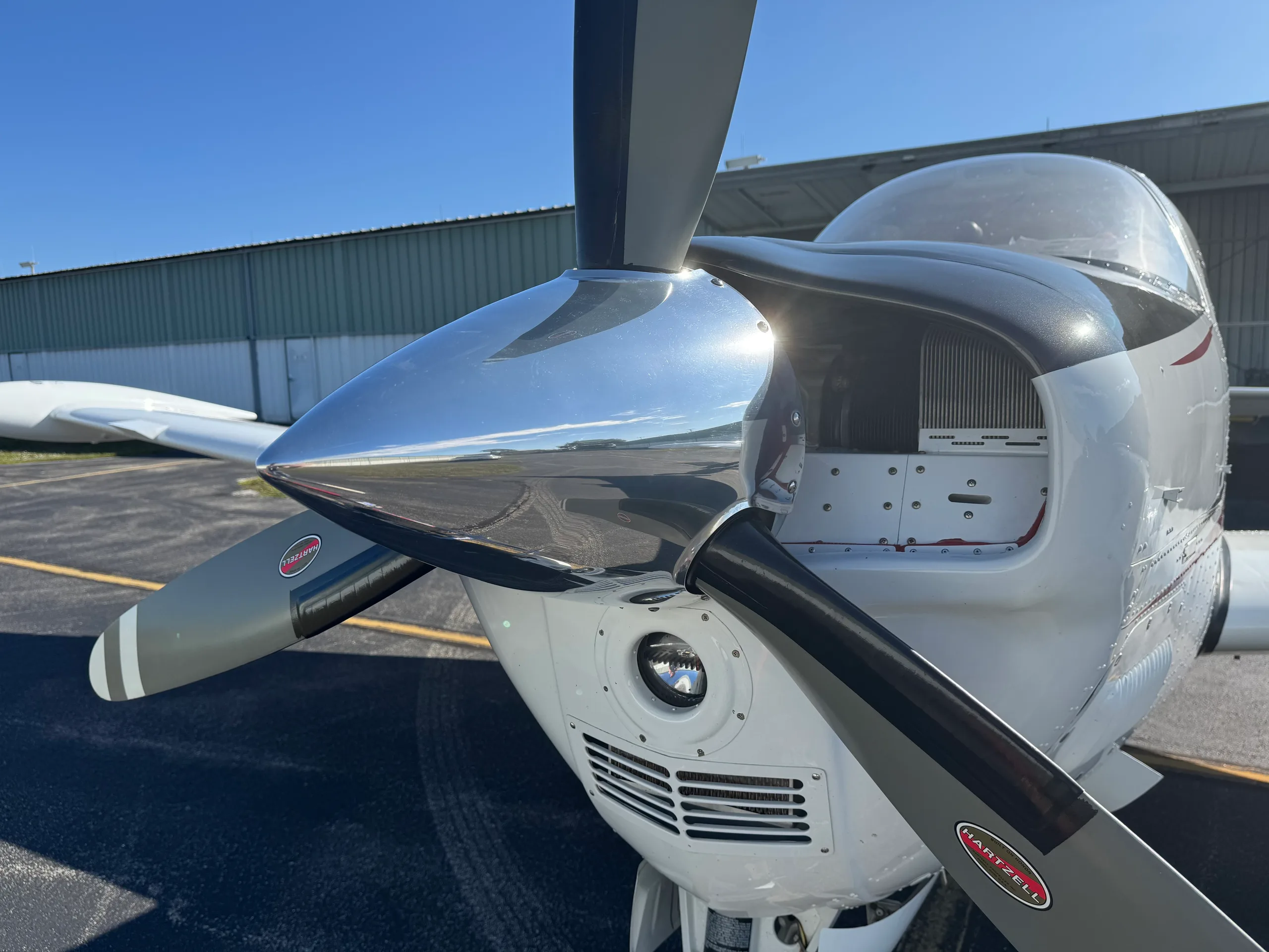 A close-up view of the polished propeller and nose cone of the Beechcraft Bonanza.