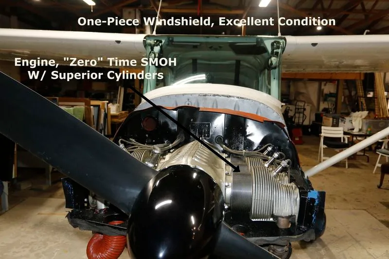 The engine compartment of a Cessna 170 aircraft with the cowling removed, showing the engine and propeller.