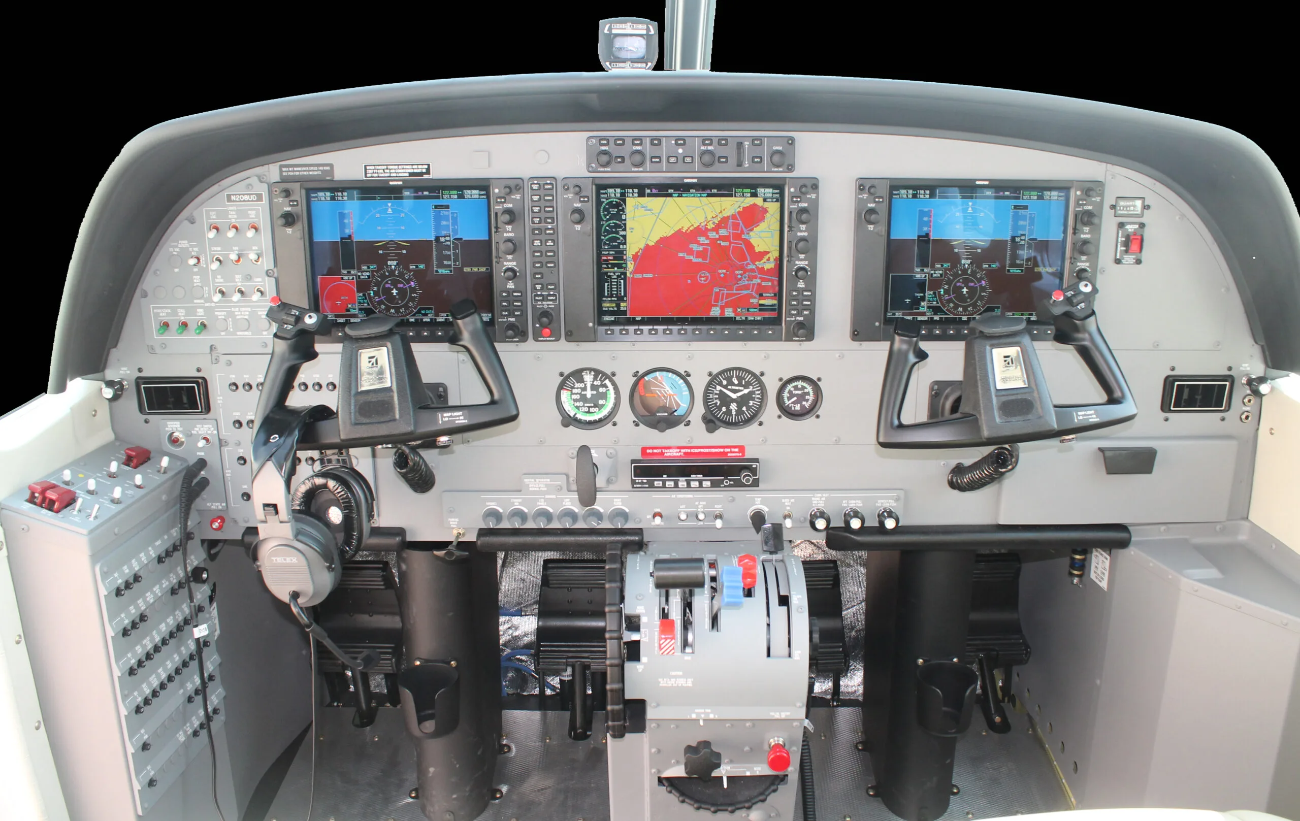 The cockpit of an aircraft features a modern glass panel with two large displays and traditional gauges.
