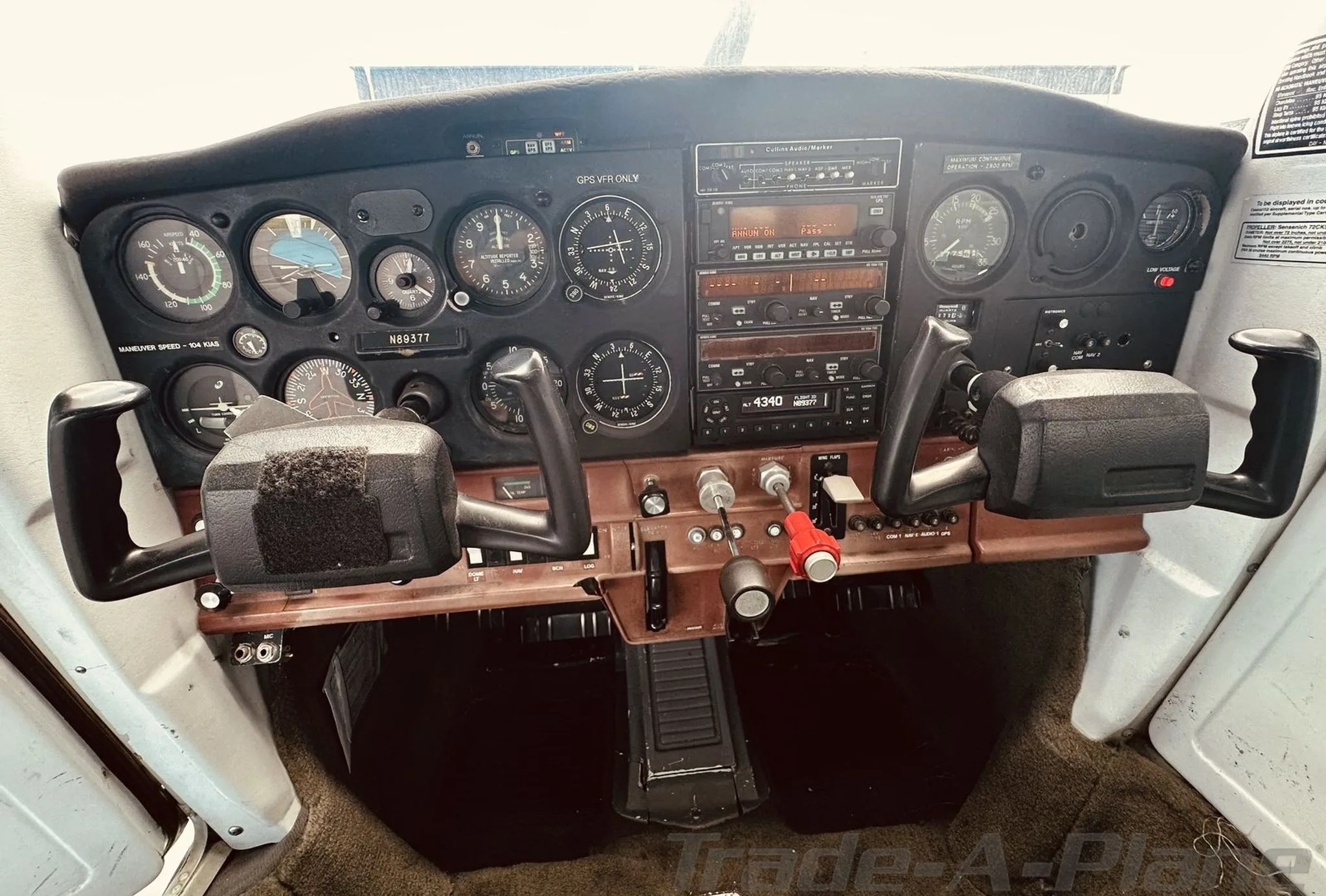 A close-up view of the instrument panel in a Cessna 172 cockpit, showing gauges, radios, and the N89377 registration.