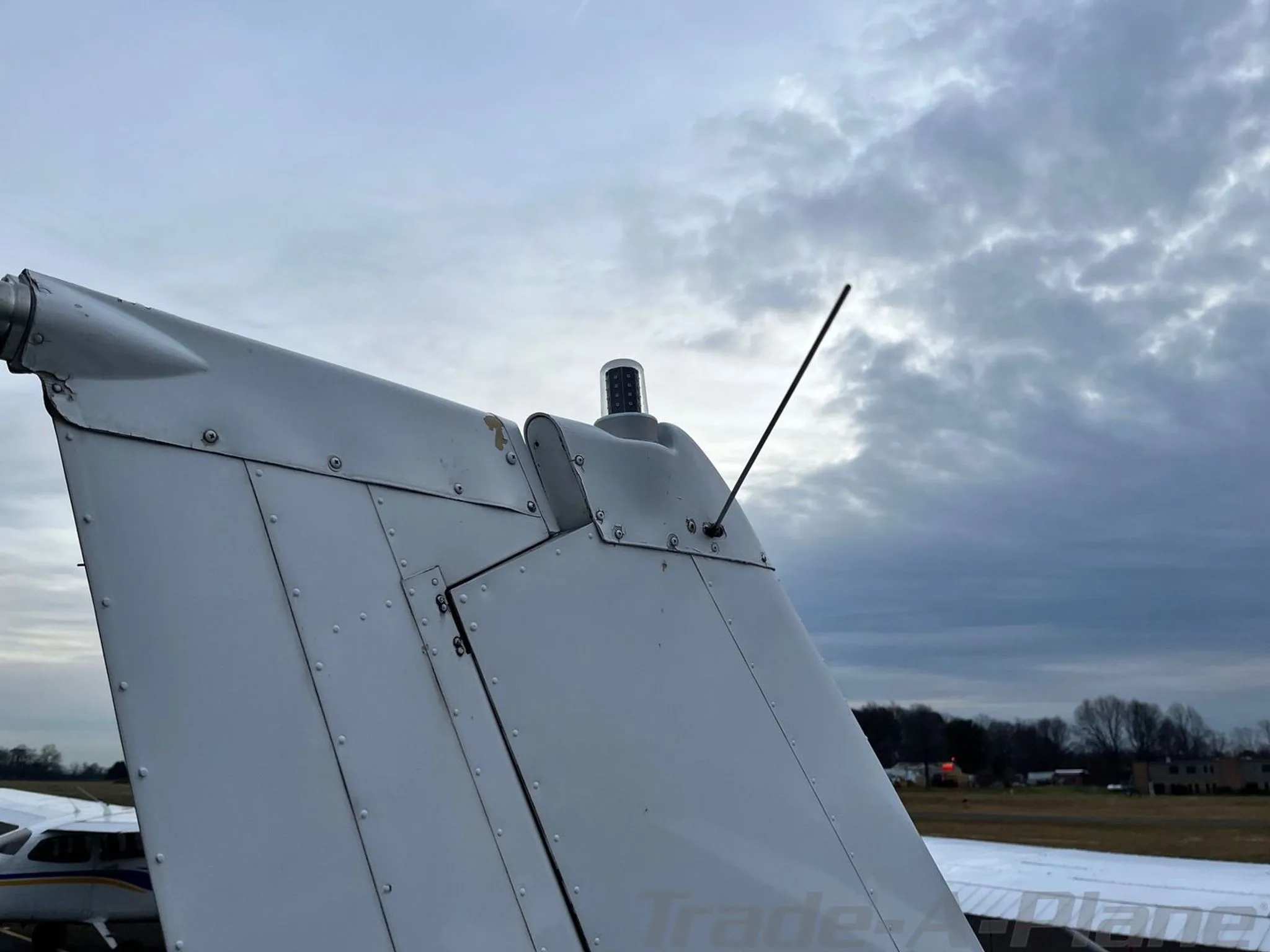 A close-up view of the vertical stabilizer and beacon light on the tail of the aircraft.