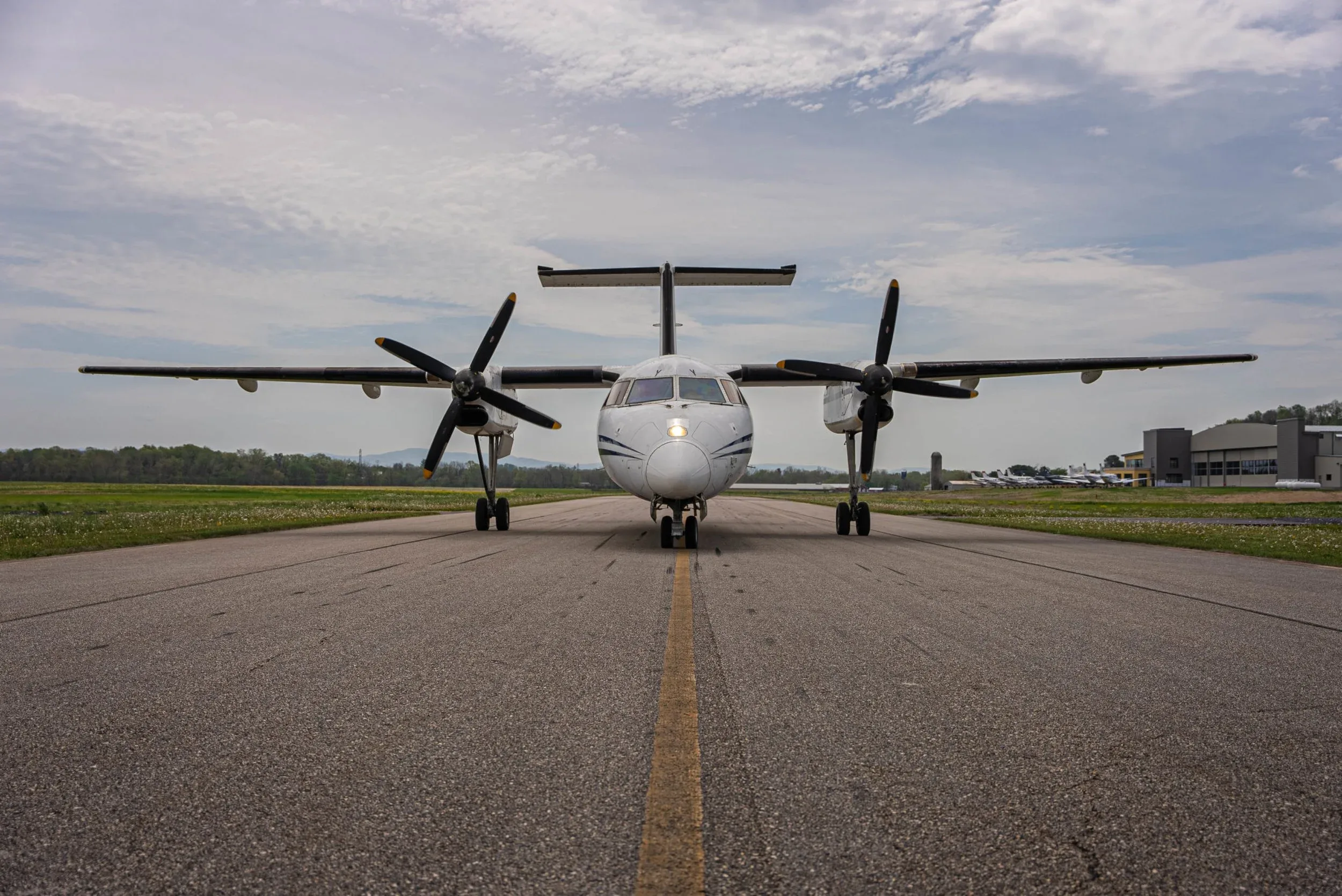 Front view of a turboprop aircraft on a runway.