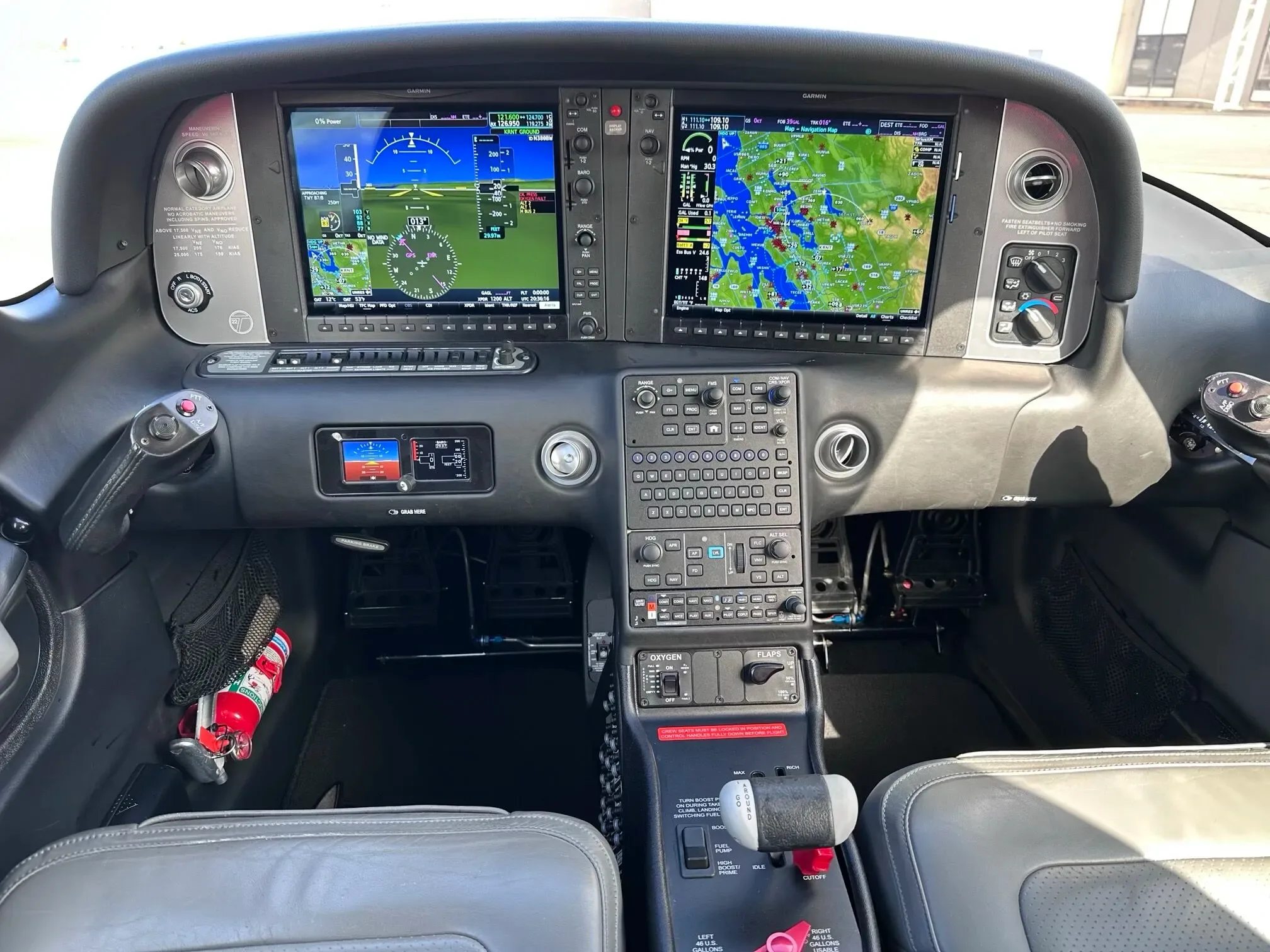 The modern glass cockpit of a Cirrus SR22 aircraft, featuring dual Garmin displays and a central control panel.