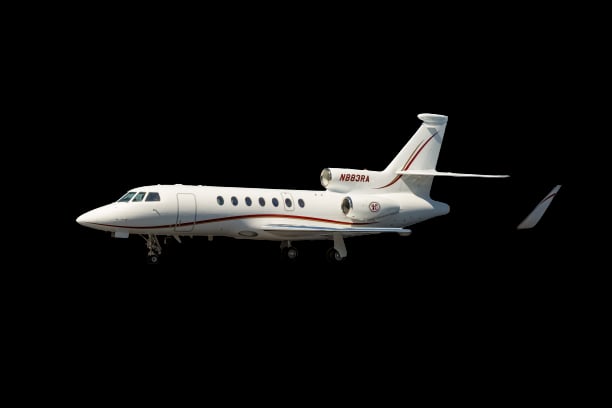 A white aircraft with red accents is shown in a side profile view against a black background.