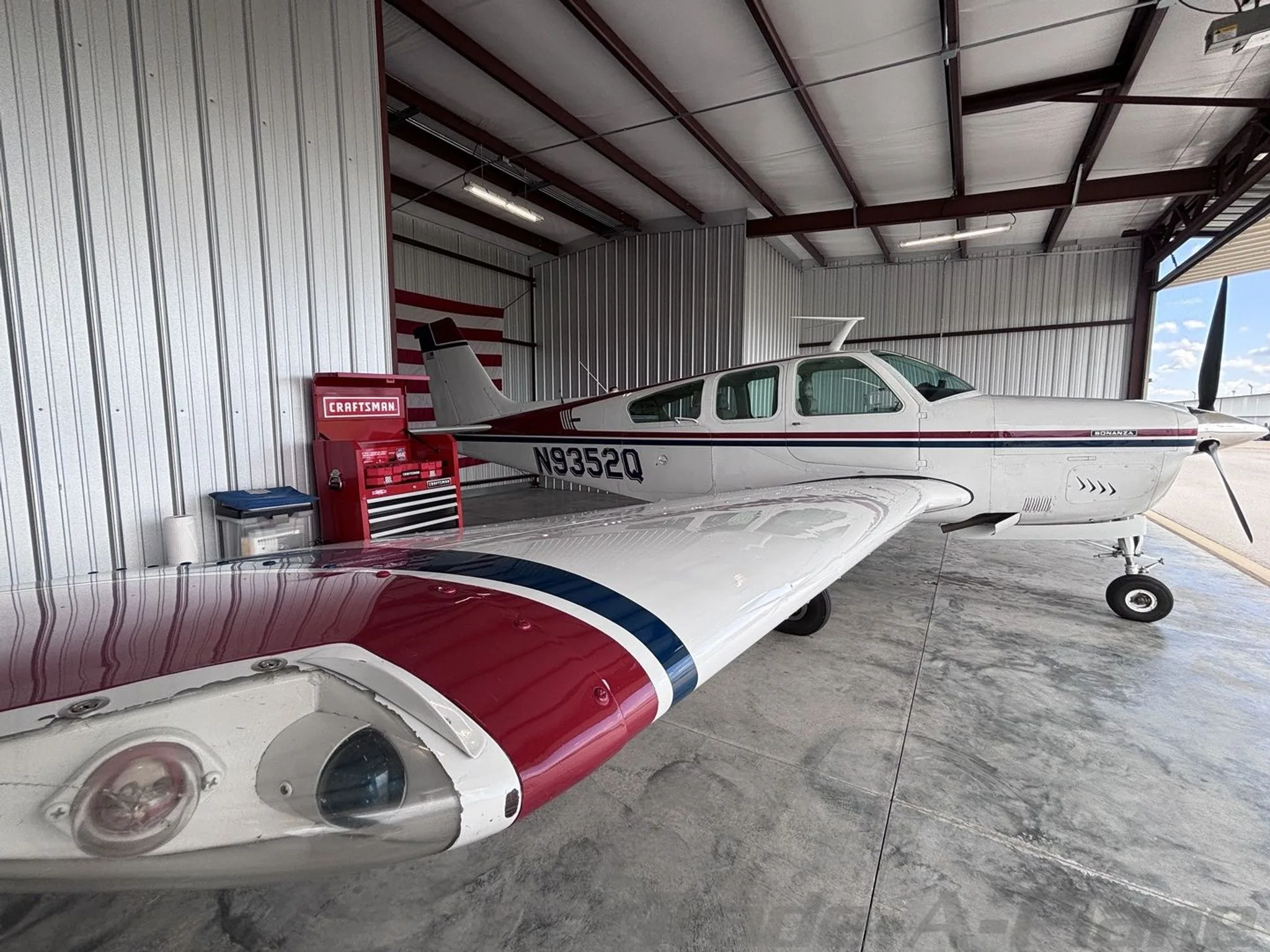Another angle of the aircraft inside the hangar, showcasing its wing and body.