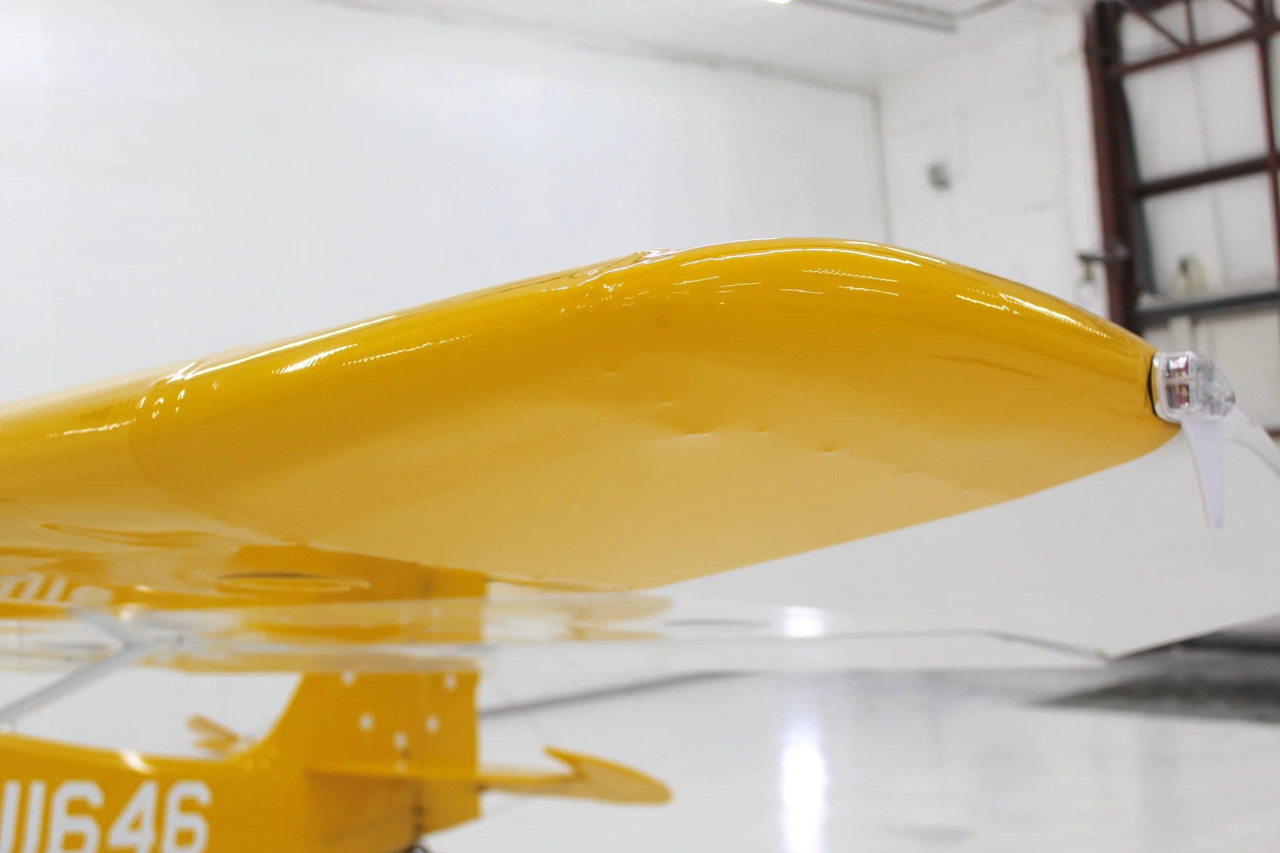 A close-up view of the yellow wingtip of the N11646 aircraft.