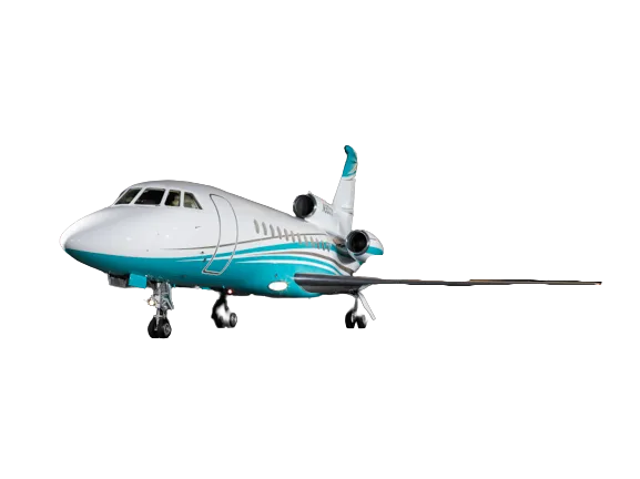 A white and teal business jet, likely a Dassault Falcon, is parked on a dark surface, viewed from the front-left.