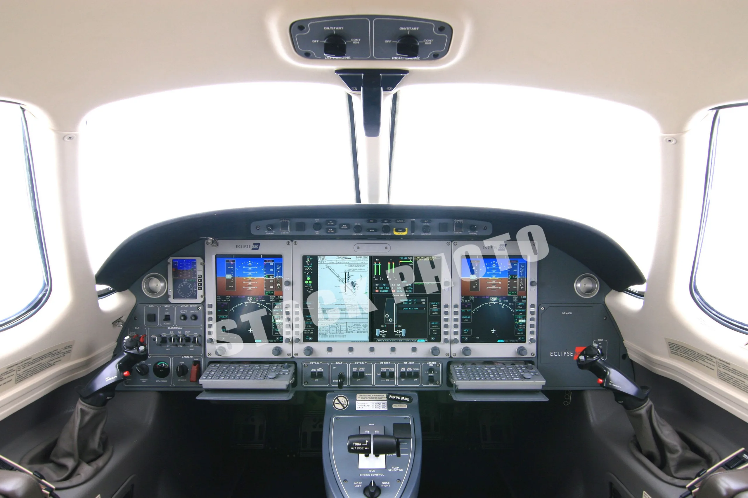 A wide view of the Eclipse 500 cockpit with multiple digital displays and controls.