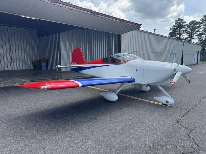 Another angle of the RV6A parked outside a hangar.