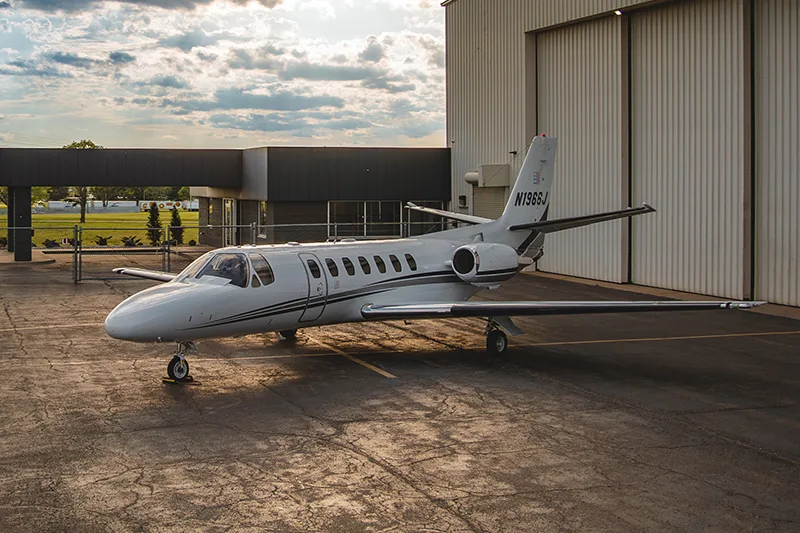 Cessna Citation CJ1+ aircraft N1966J parked outside a hangar.