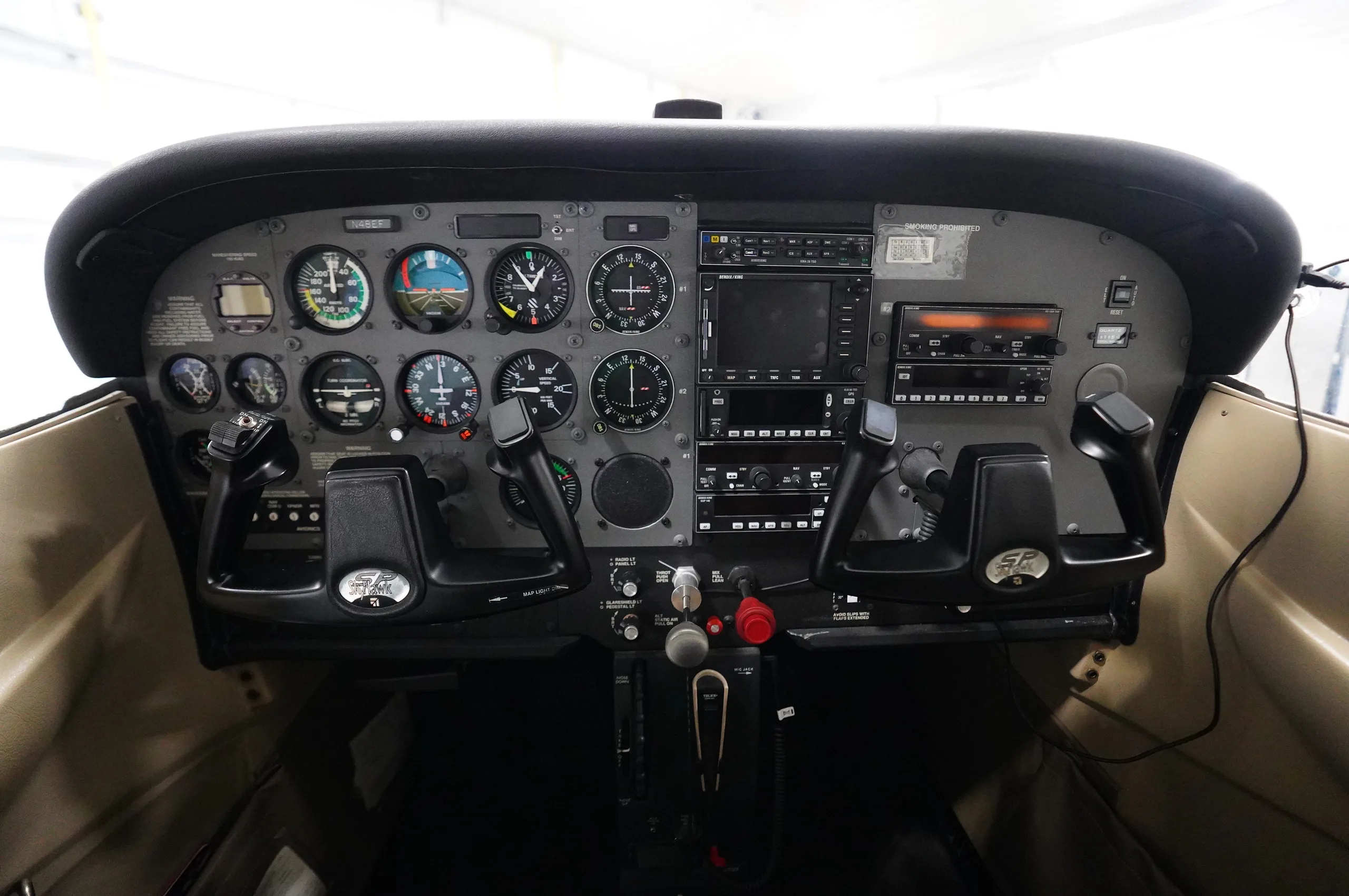 The instrument panel and dual yokes of a Cessna 172 cockpit.