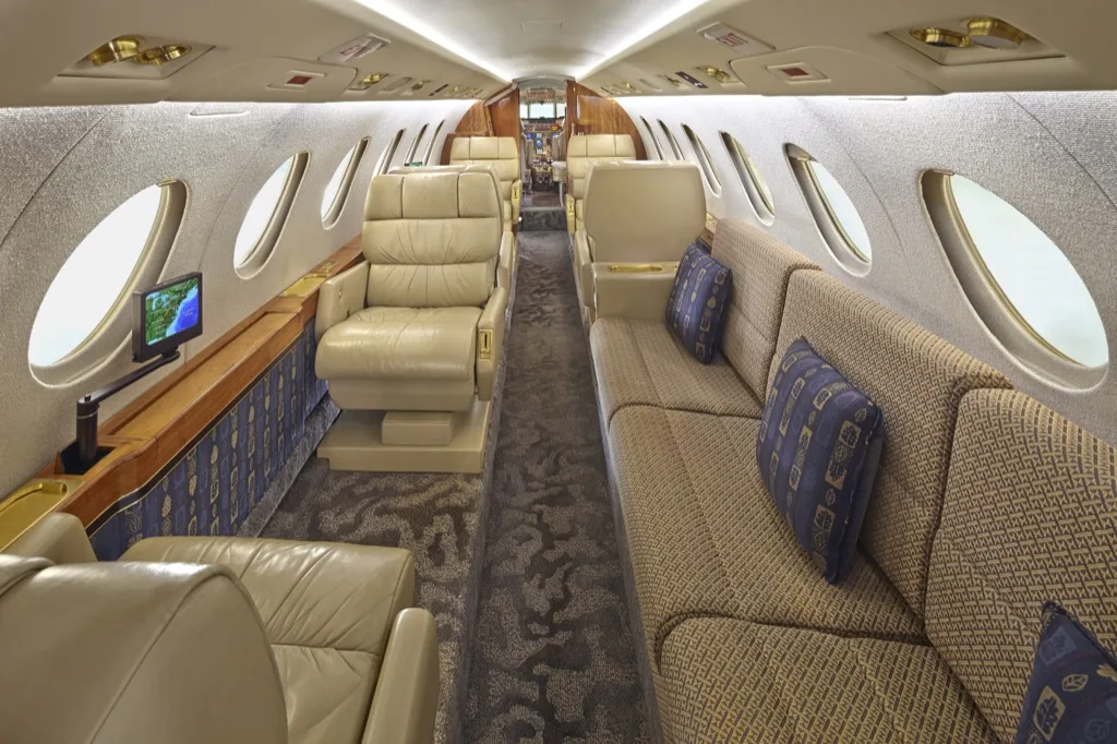 Hawker 850XP cabin interior with leather seats and a sofa.