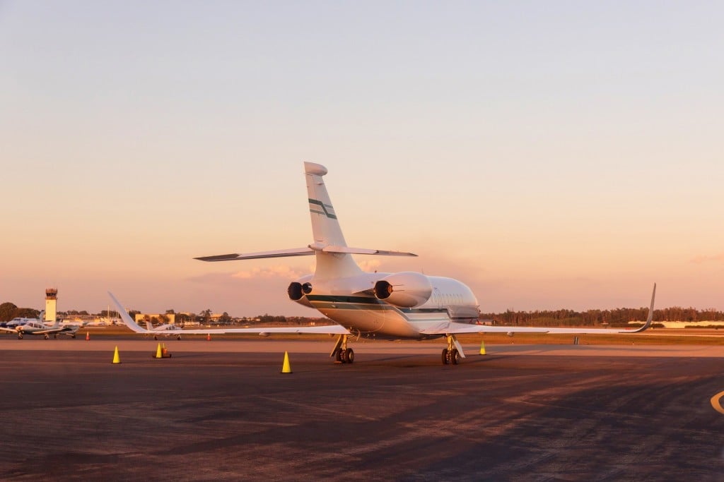 A Citation Latitude aircraft parked on the tarmac at sunset.