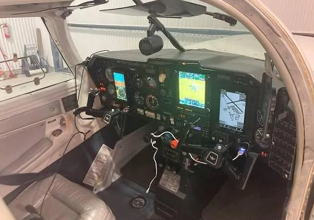 View of the aircraft's cockpit showing the instrument panel with multiple screens and controls.
