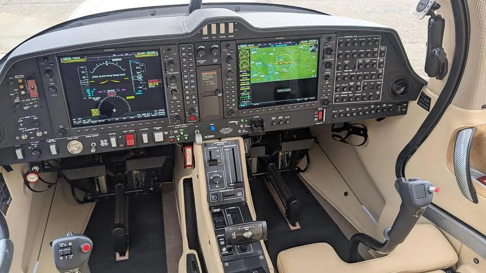 The modern glass cockpit of a small aircraft, featuring multiple digital displays and controls.
