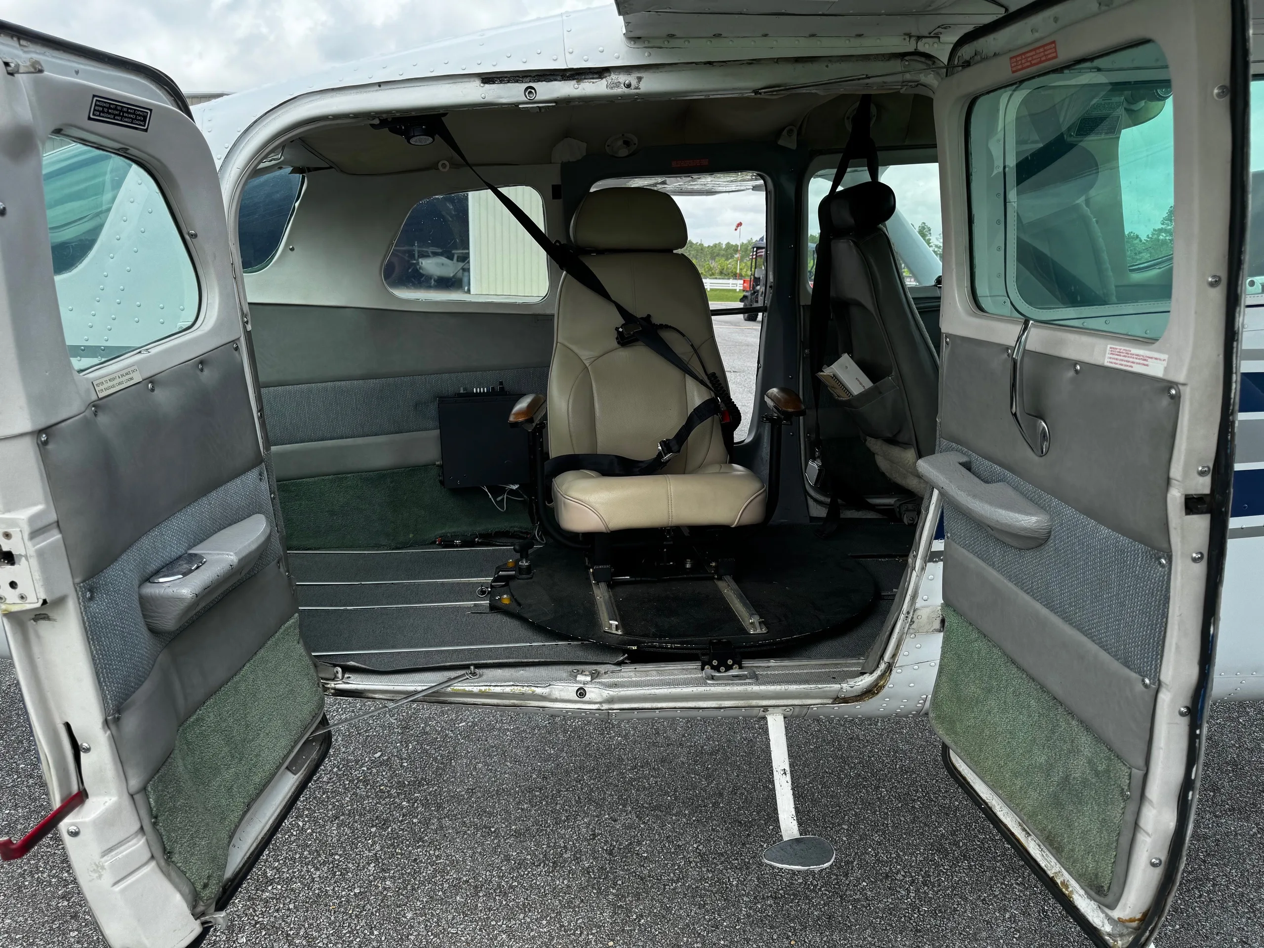 Interior view of the Cessna 206 Turbo Stationair cabin with seats and open doors.