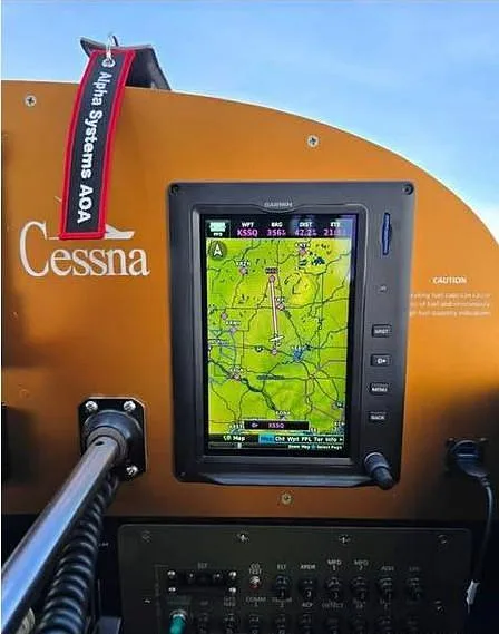 A close-up view of a Garmin navigation display showing a map, mounted in the cockpit of a Cessna aircraft.