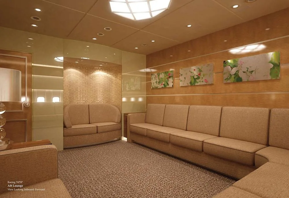 A rendering of a spacious aft lounge in a Boeing 747SP, featuring long beige sofas and artwork on the walls.