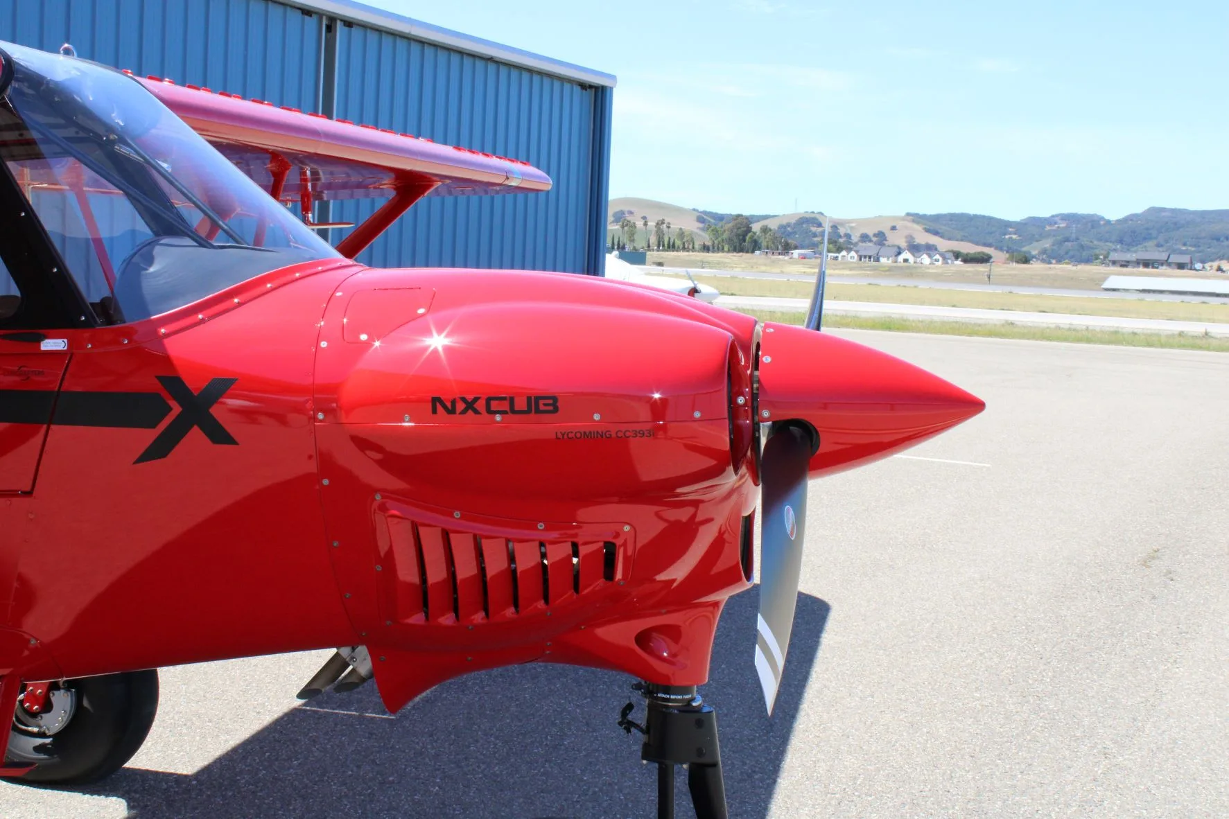 Interior view of the NX Cub aircraft showing the black leather seats with seatbelts.