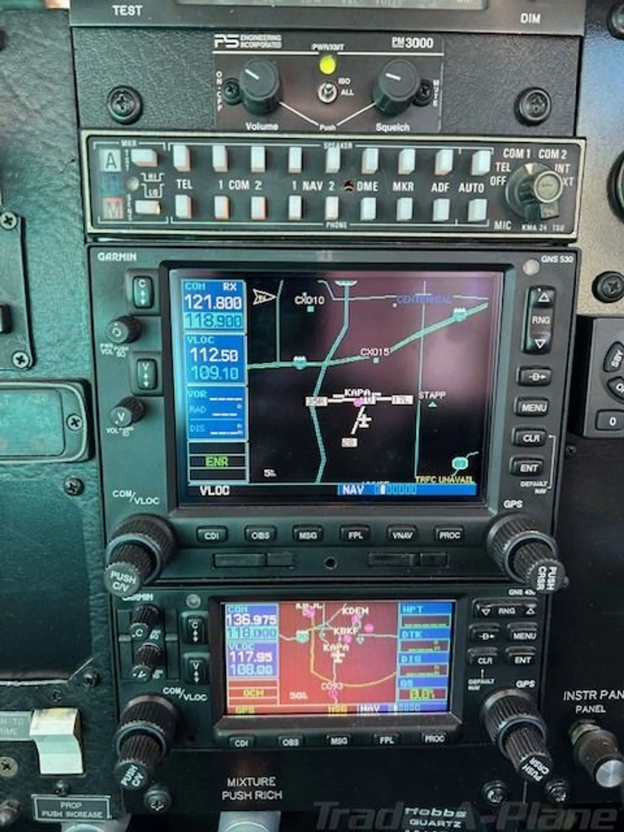 Close-up of the aircraft's avionics stack, including a Garmin GNS 530 display showing a map.