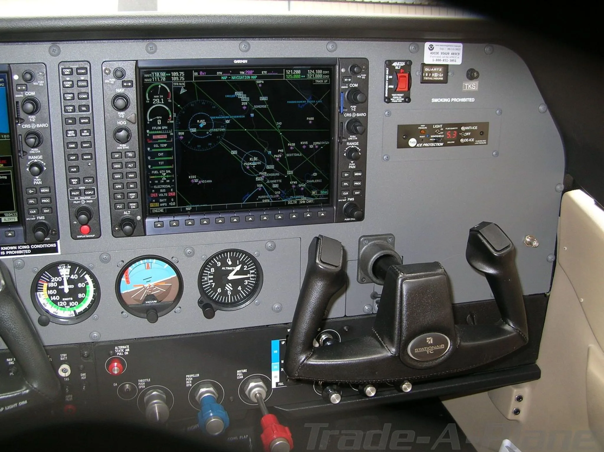 The cockpit instrument panel of a Cessna Stationair TC, featuring a large Garmin G1000 display and traditional gauges.