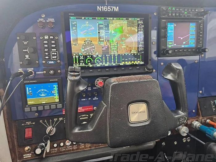 The cockpit of a Cessna 182 Skylane, featuring a modern glass panel display and a "SKYLANE" branded yoke.