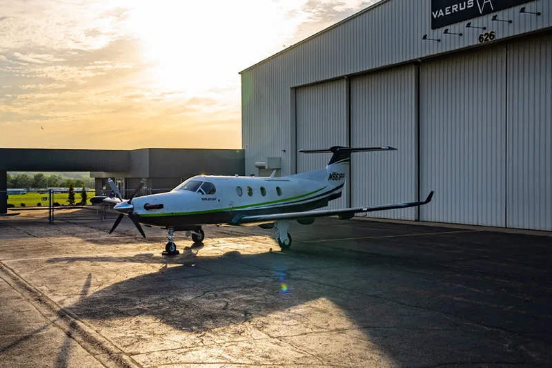 Pilatus PC-12 aircraft N861PP parked in front of a hangar.