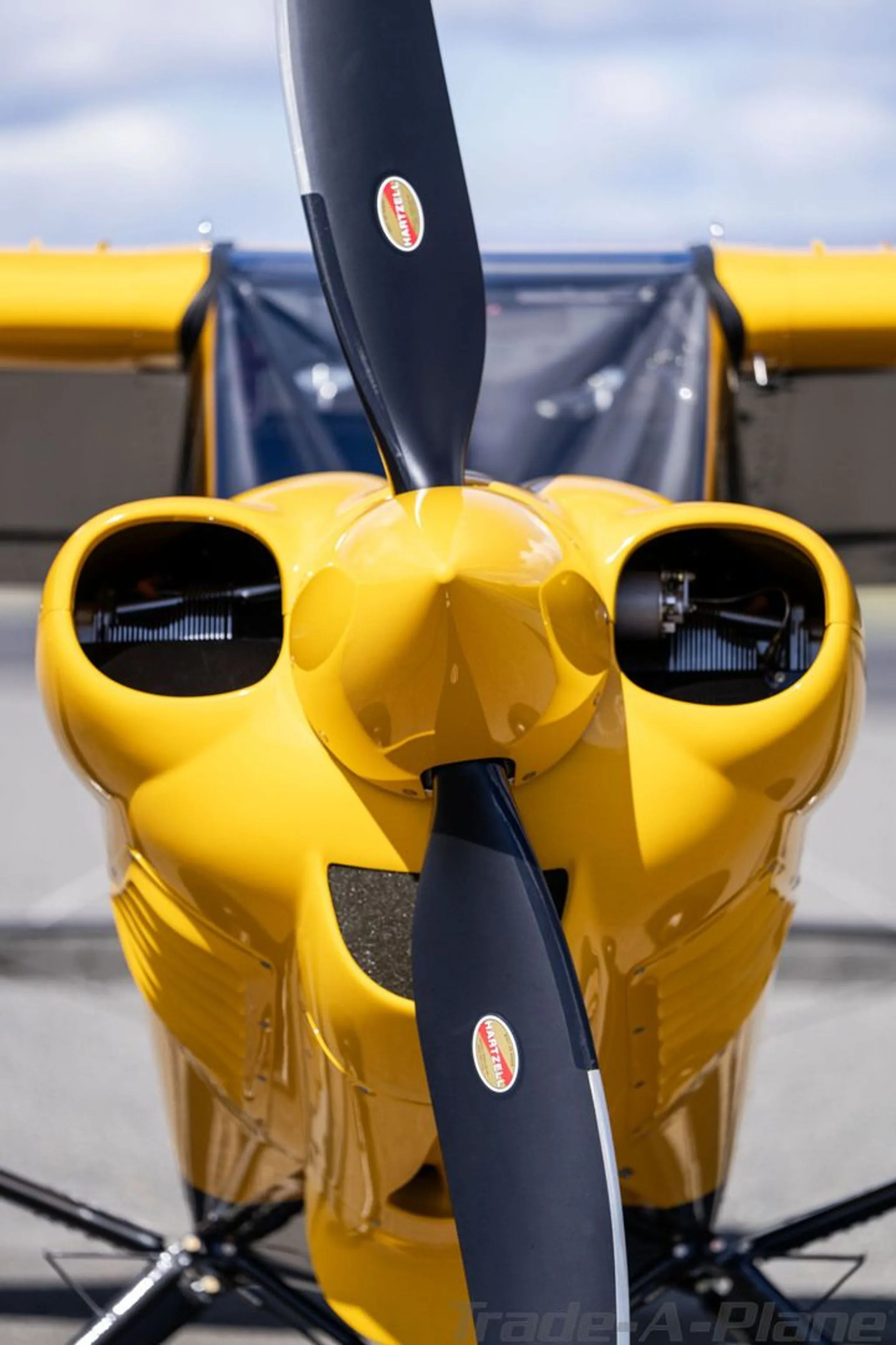 A close-up view of the yellow engine cowling and black propeller of a Carbon Cub FX3.