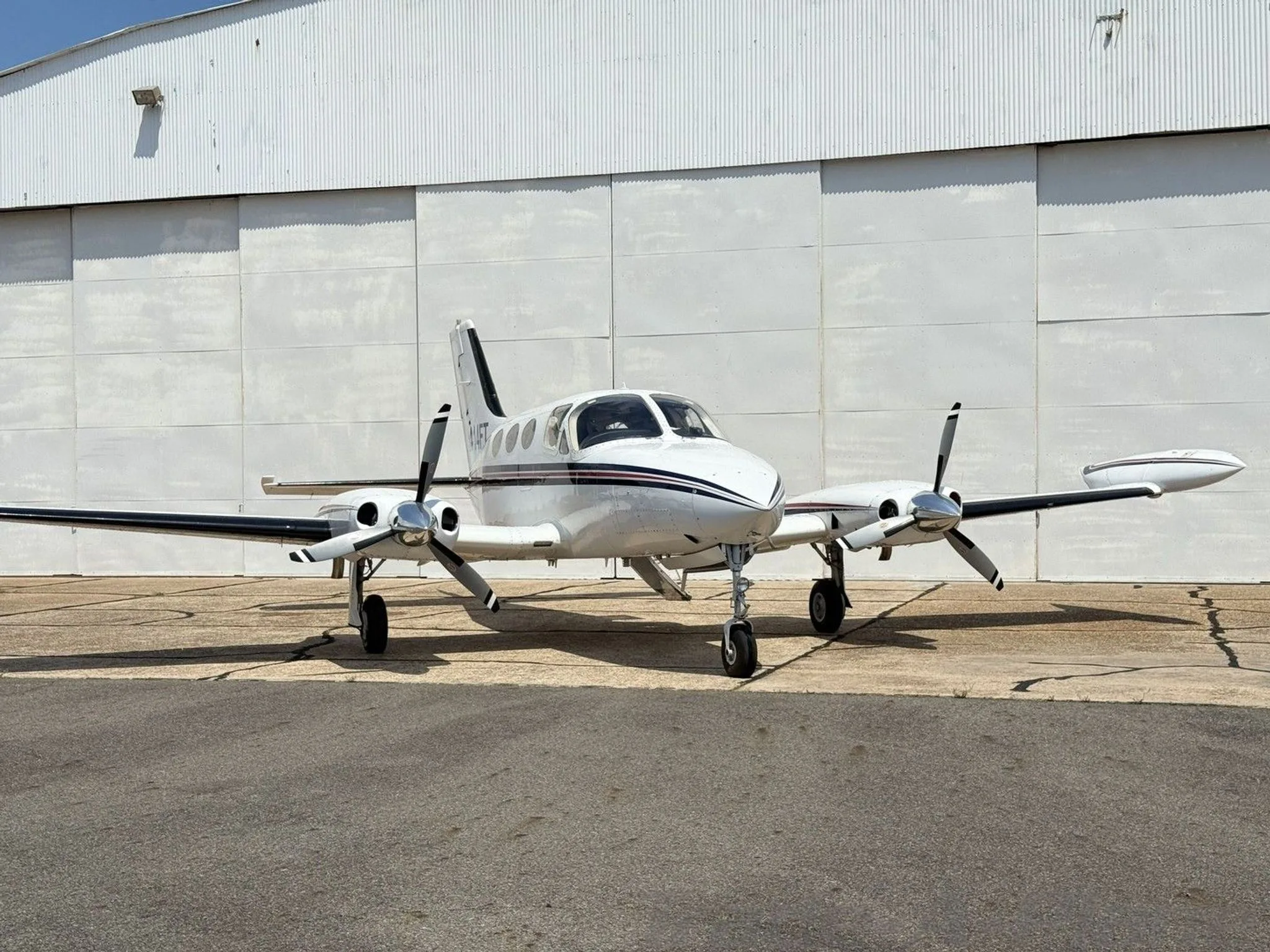 Front view of the Cessna 414 parked at a hangar.