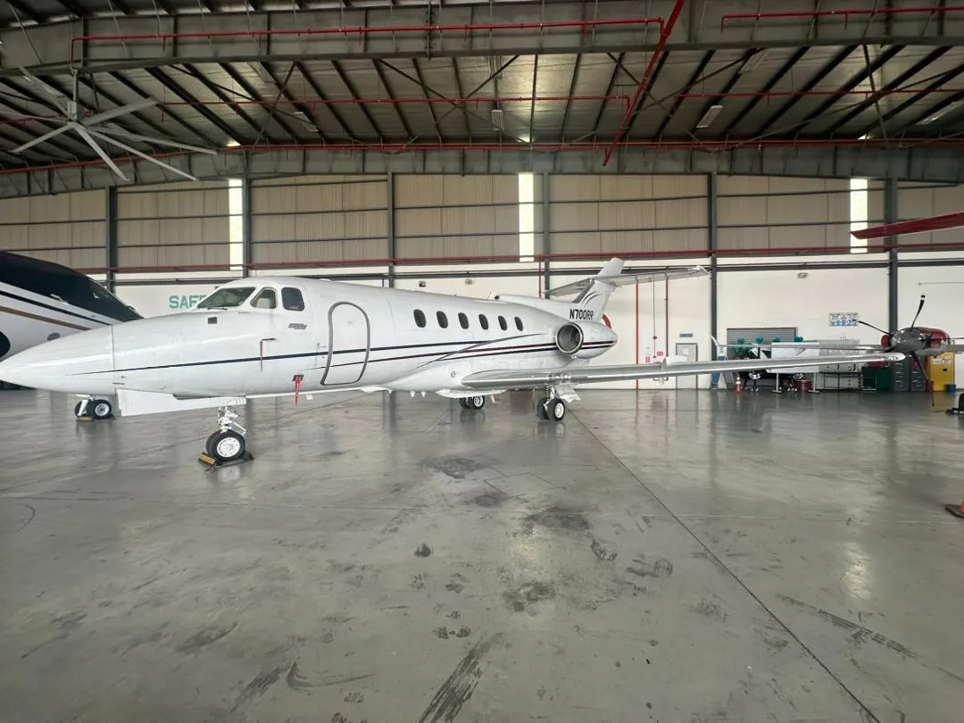 A Hawker 400XP aircraft with registration N700RR is parked inside a hangar.
