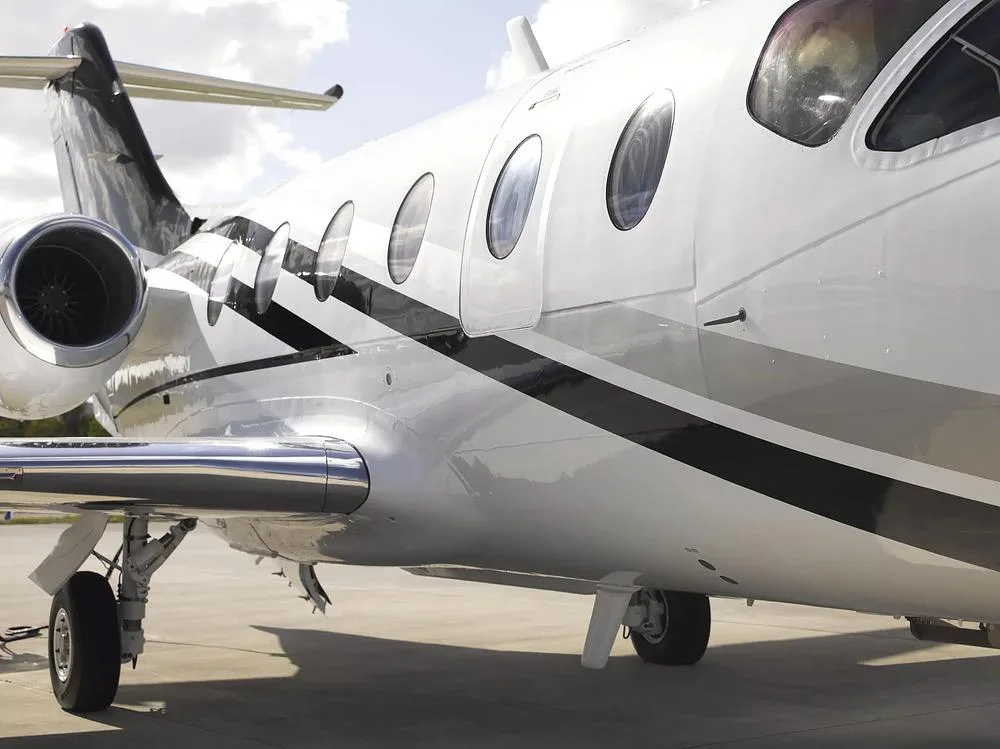 A close-up of the rear fuselage, engine, and main landing gear of the white Cessna Citation M2, N440LN.