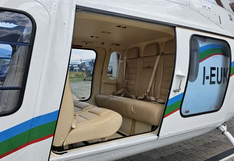 Interior view of the AgustaWestland AW109 helicopter cabin with beige leather seats.