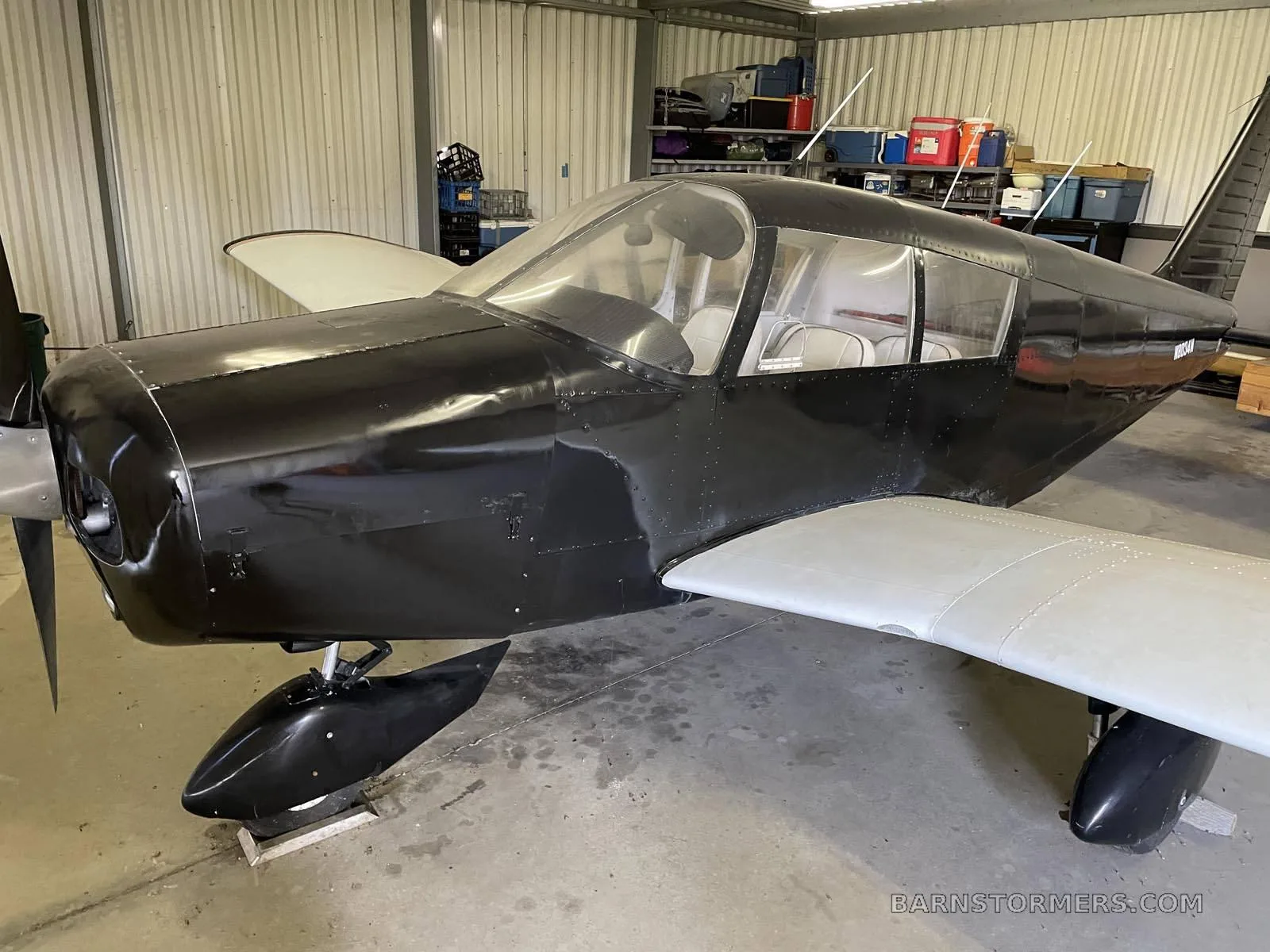 A close-up view of the aircraft's front in a hangar.