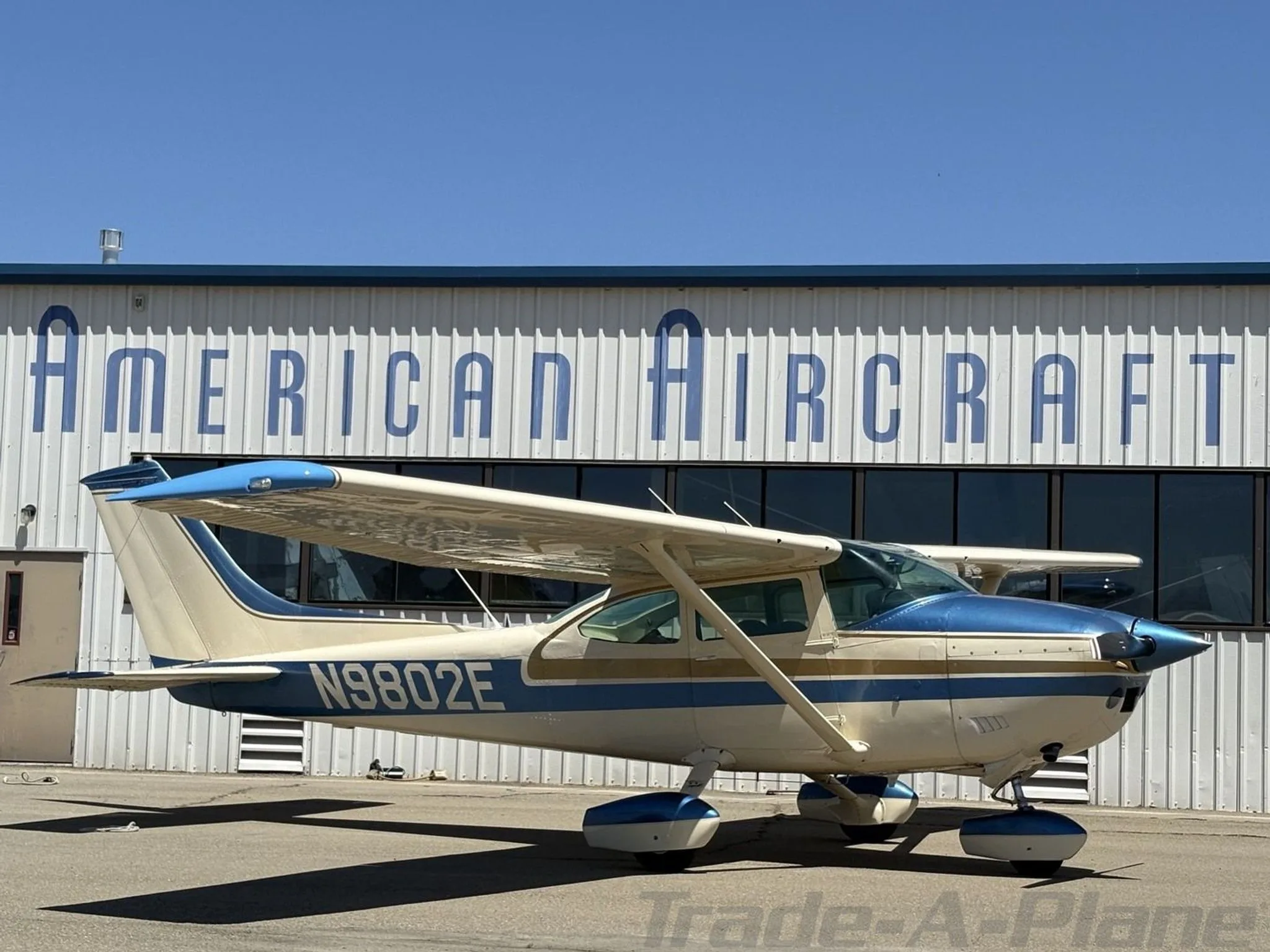 A Cessna 182P Skylane parked in front of an aircraft hangar.