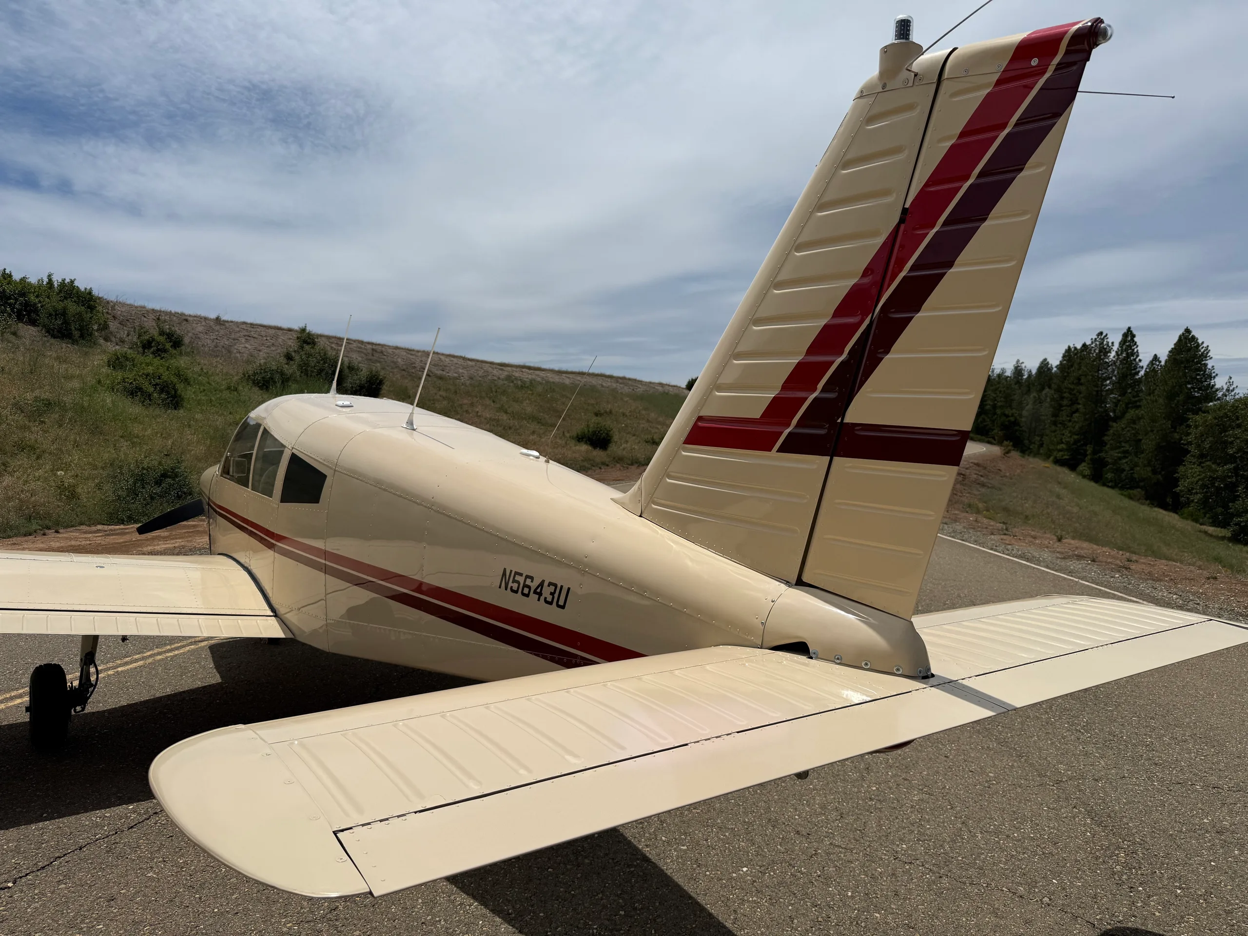 Close-up rear view of the N5643U aircraft's cream and red tail section.