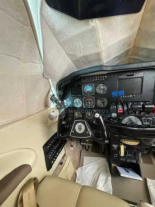 A view of the left side of the aircraft cockpit, highlighting the pilot's yoke and instrument panel.