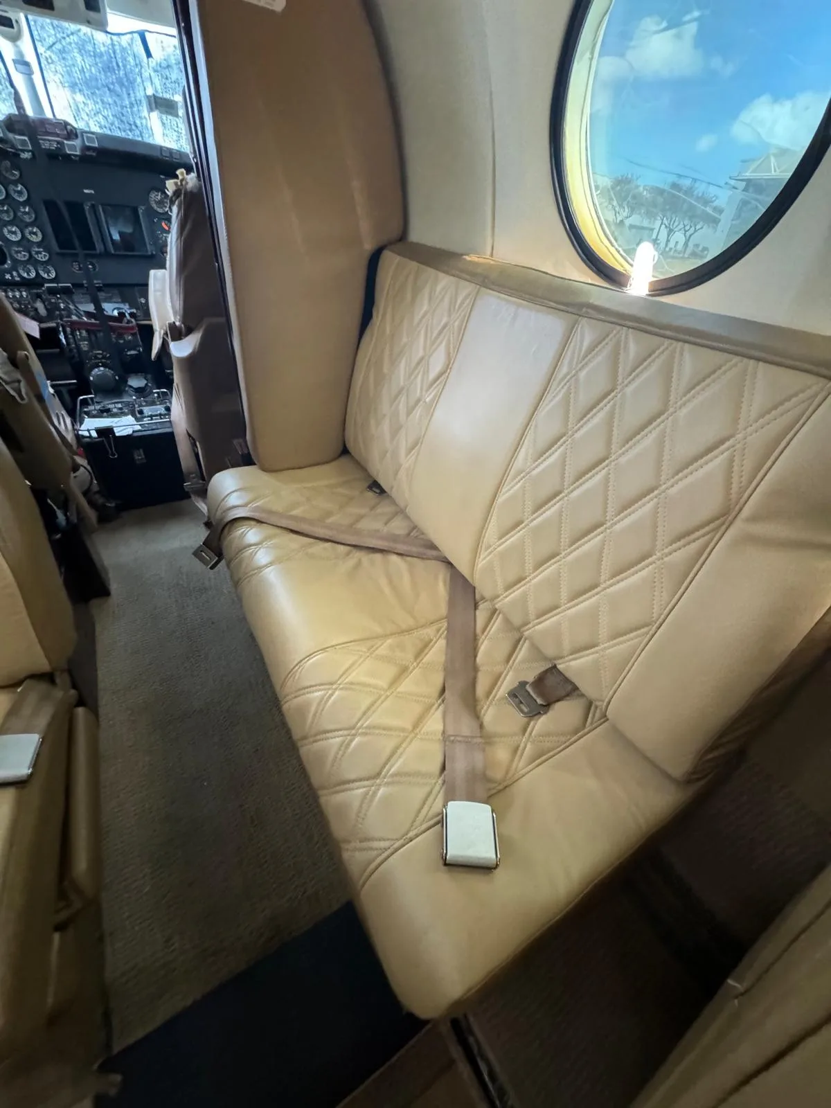 Interior view of the King Air 200 cabin with tan leather seats.