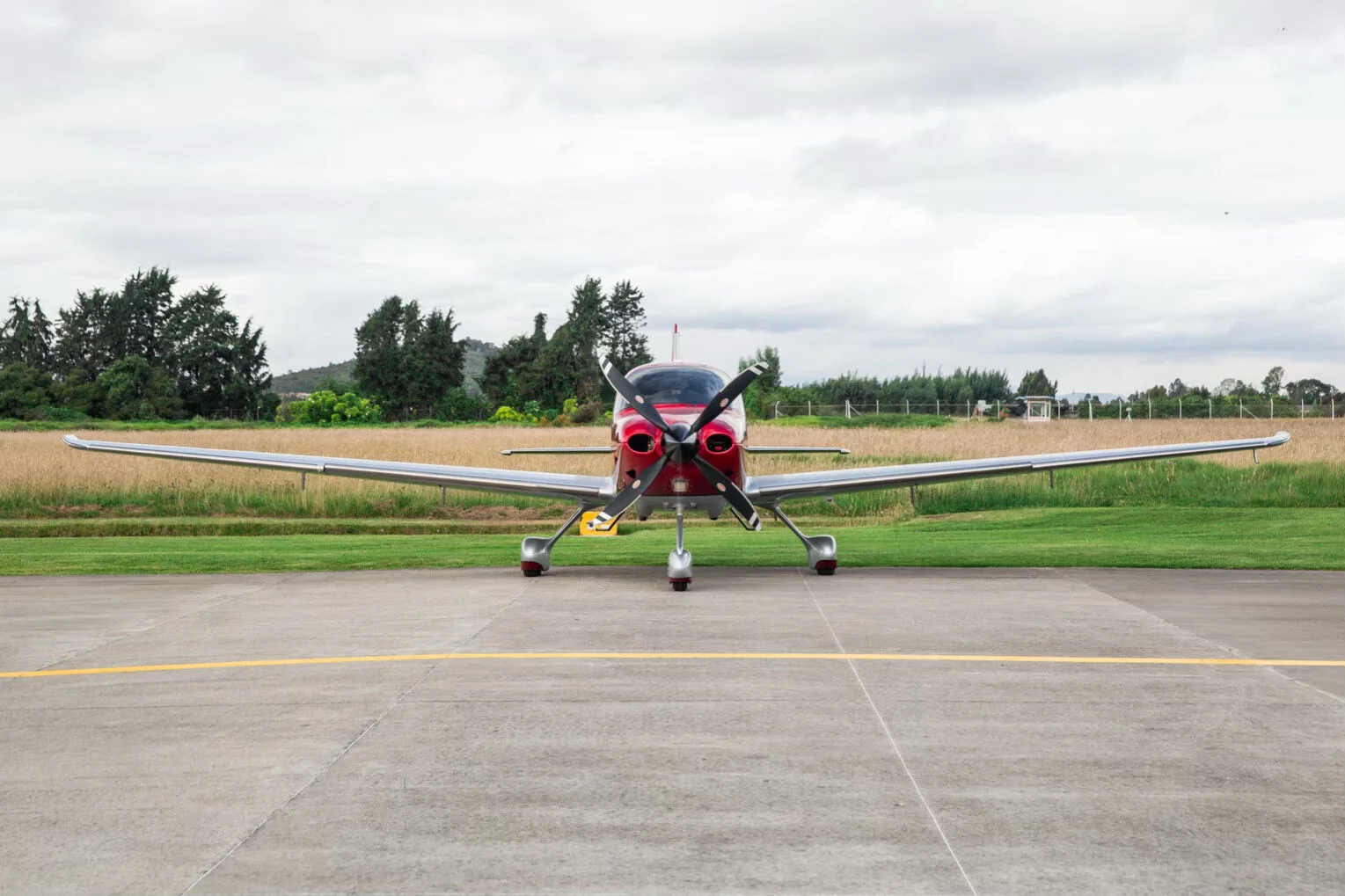 Front view of a red and silver Cirrus SR22T aircraft, registration N785SY, parked on an airfield.