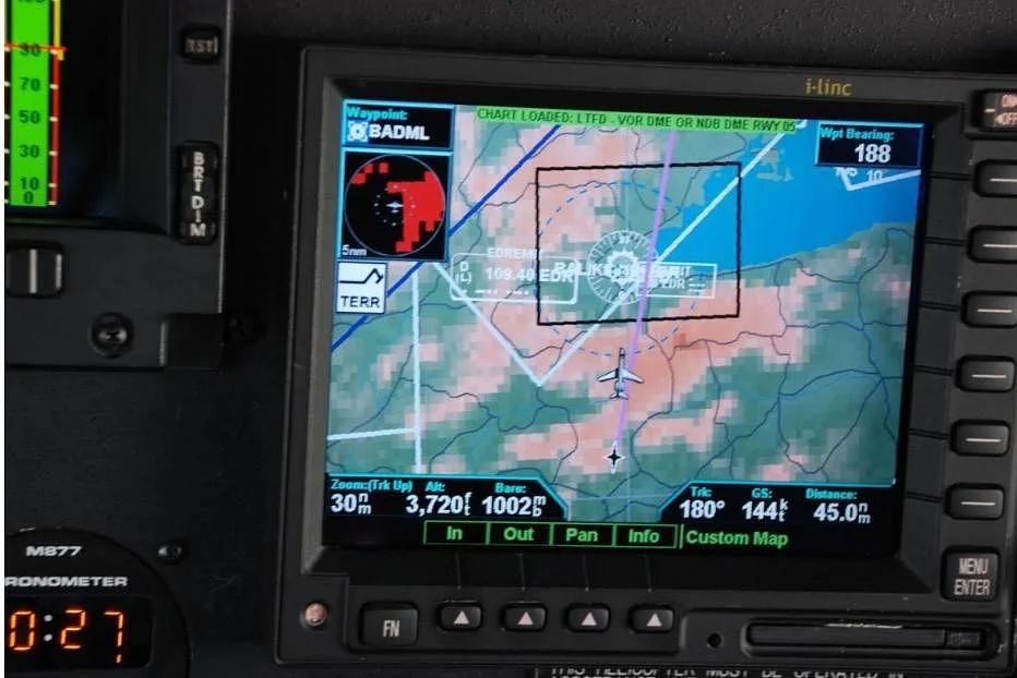 A close-up of a helicopter's navigation display showing a map with flight path and terrain.