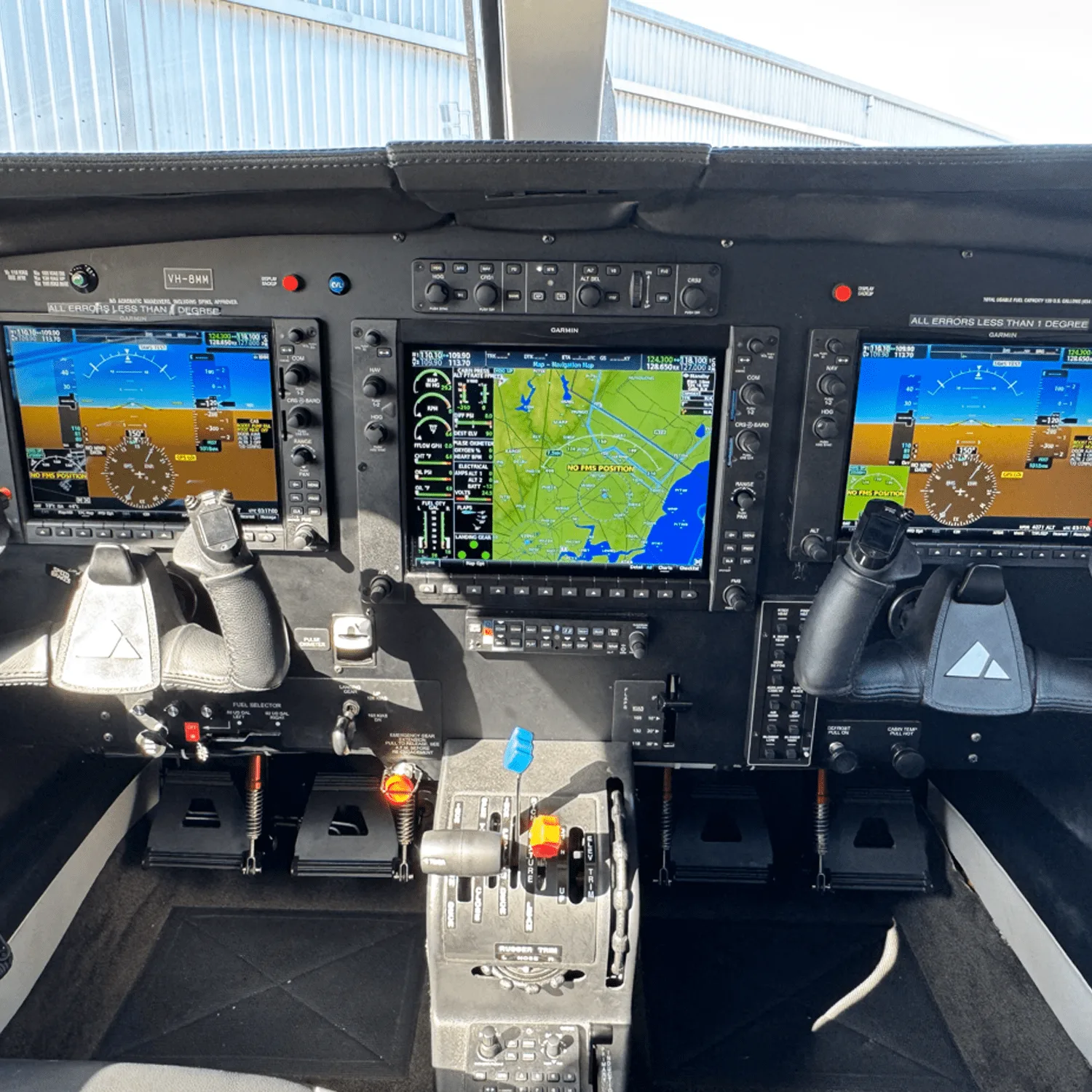 The modern glass cockpit of a Piper M350 aircraft with multiple Garmin displays.