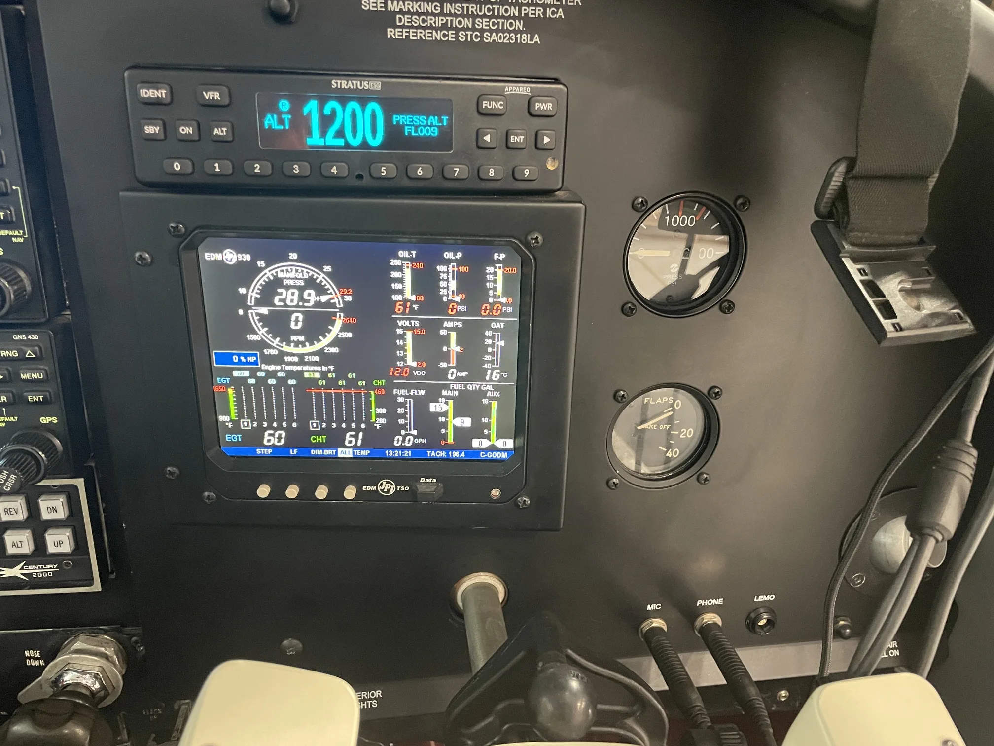 A close-up of an aircraft's instrument panel, showing a digital engine monitor and other flight instruments.