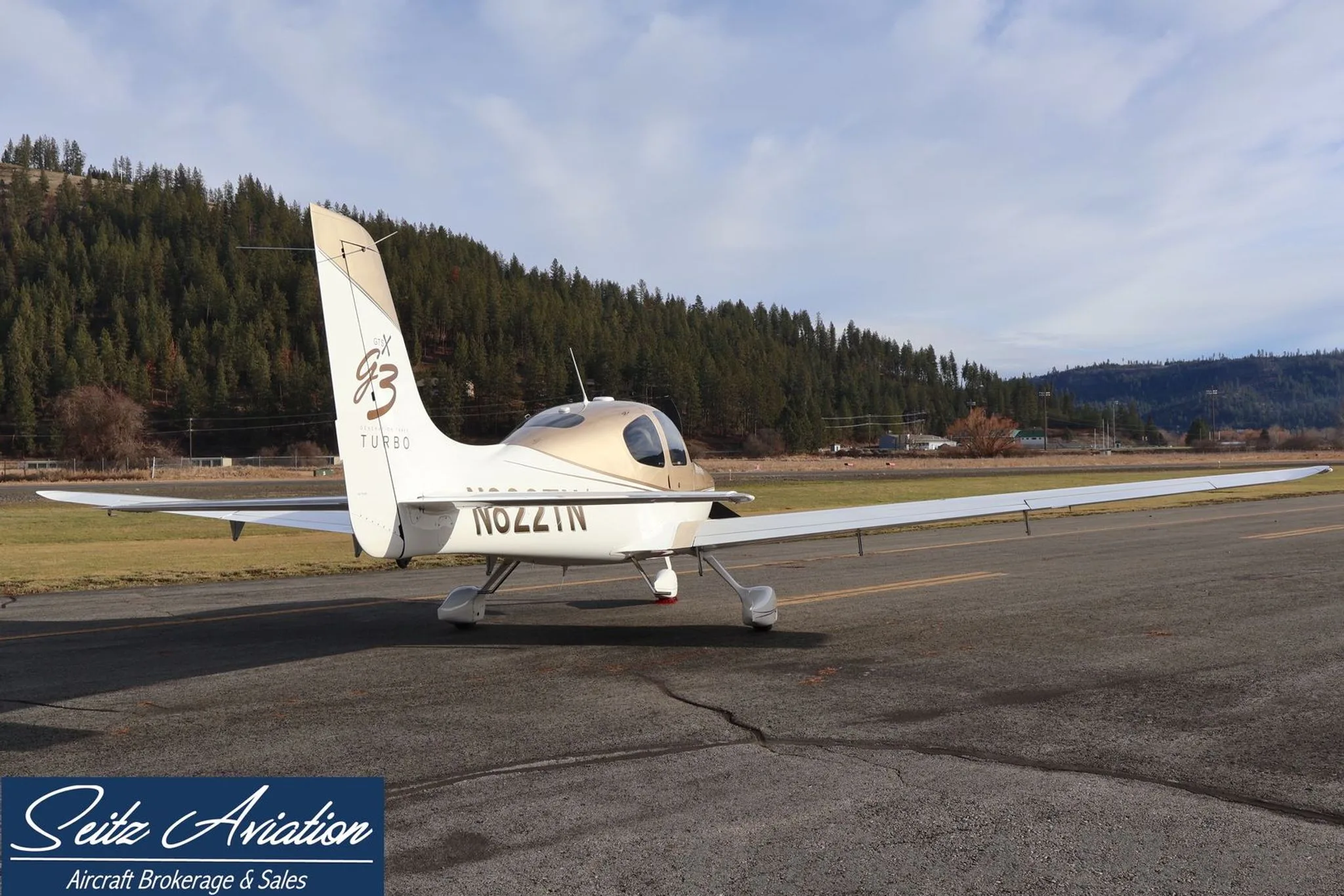 Rear-side view of the Cirrus SR22T aircraft N822TN, showing its tail and registration, parked on an asphalt ramp.