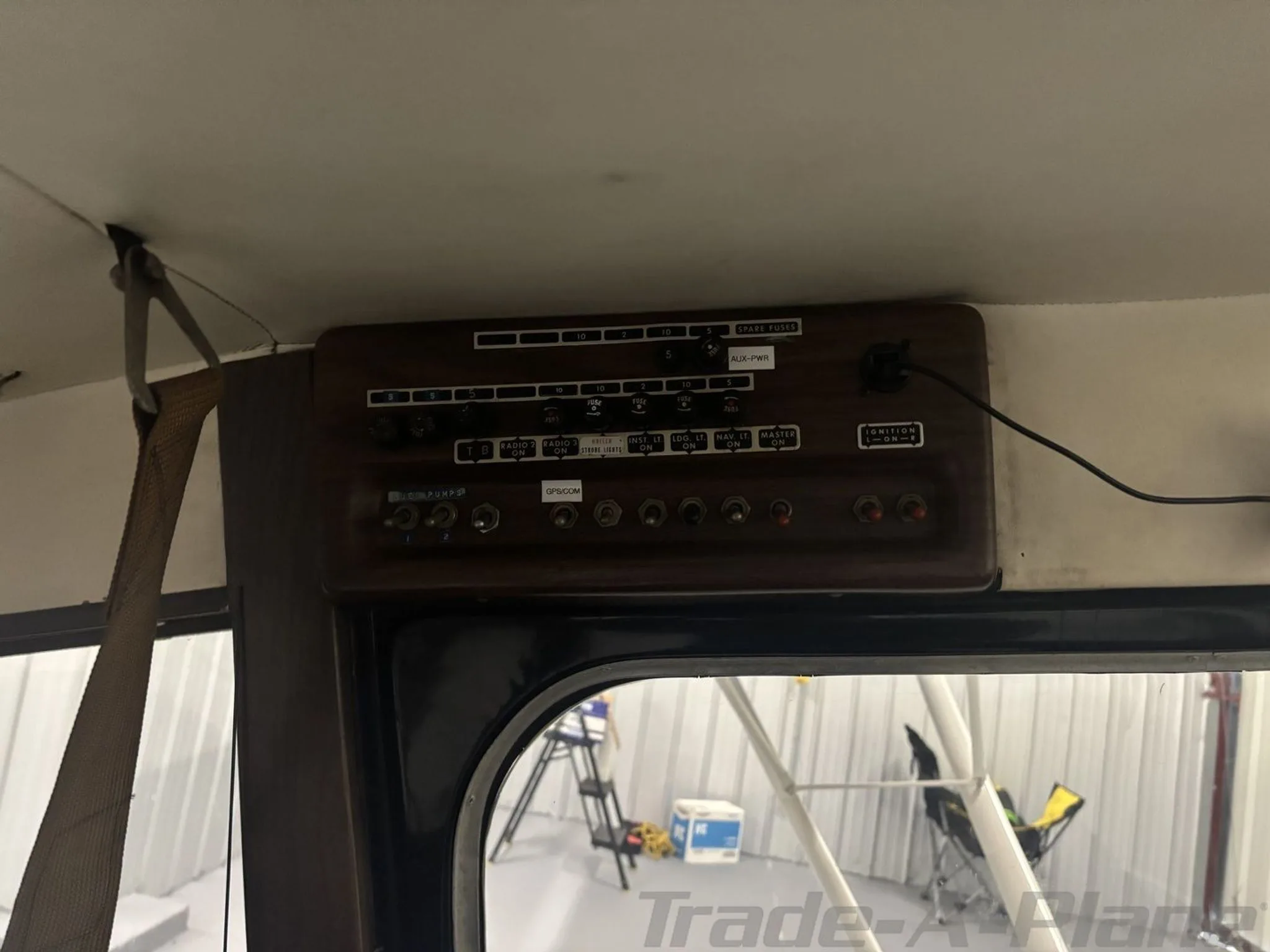 An overhead panel inside the aircraft with various switches, fuses, and labels.