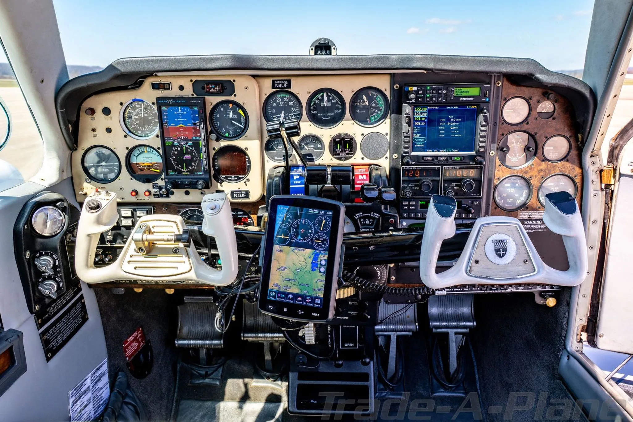 Detailed view of the N4UF aircraft's cockpit instrument panel with dual yokes and modern avionics.