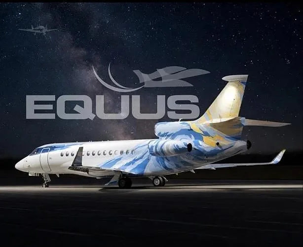 A private jet with a distinctive blue and yellow swirl paint scheme is parked on a tarmac under a starry sky.