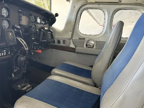 The interior of the aircraft features blue and gray seats.
