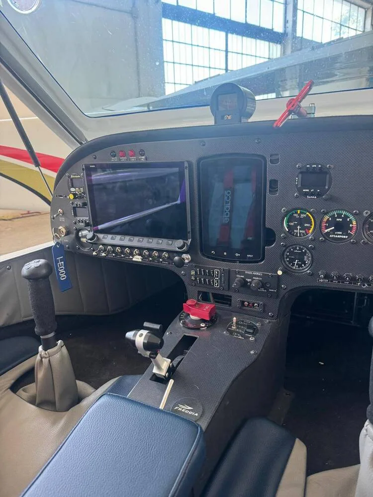 The cockpit of a Freccia aircraft showing the instrument panel with digital displays and controls.